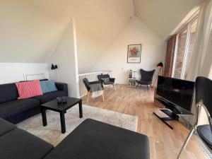 a living room with a couch and a piano at 1160-Romo-Gulirisvej-160 in Høm