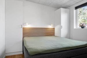 a bedroom with a large bed with a wooden headboard at LF302-Hurup-Helligsovej-2-F in Hurup