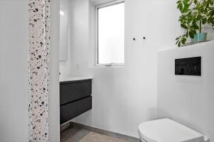 a bathroom with a toilet and a sink and a window at LF302-Hurup-Helligsovej-2-F in Hurup +23 photos
