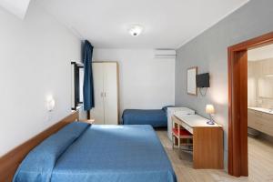a bedroom with a blue bed and a desk at Marina Living Rooms and Pool in Paestum +285 photos