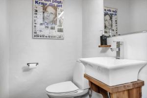 a bathroom with a white sink and a toilet at LF271-Vestervig-Gunhildsvej-49 in Vestervig +19 photos