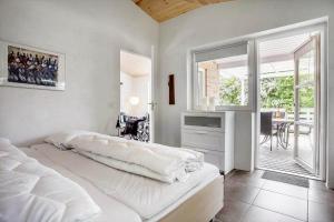 a bedroom with a large white bed and a table at LF271-Vestervig-Gunhildsvej-49 in Vestervig