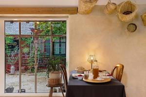 a table with a black table cloth and a window at Dordinaire Maison D'hôtes in Nouans-les-Fontaines