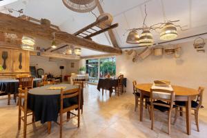 a restaurant with tables and chairs in a room at Dordinaire Maison D'hôtes in Nouans-les-Fontaines +50 photos