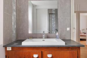 a bathroom with a white sink and a mirror at Le Café de l'Encloître in Beaumont-la-Ronce +27 photos