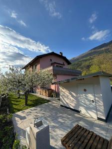 a house with a white garage in front of a house at Apartment Nona Polda in Kobarid