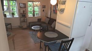 a living room with a couch and a table at Skrædderens Baghus in Assens +10 photos