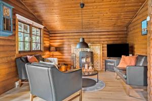 a living room with leather furniture and a television at LF14362-Roslev-Nautrupvej-62 in Roslev