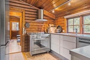 a kitchen with a stove and a sink at LF14362-Roslev-Nautrupvej-62 in Roslev