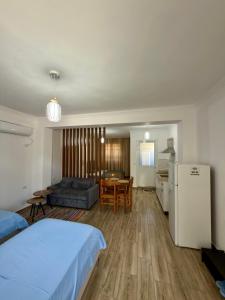 a bedroom with a bed and a kitchen and a living room at Appartments Kristi&Iris in Vlorë