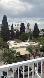 a balcony with a view of a parking lot with cars at Topfix Luxury Home 2 in Kos