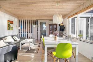 a dining room with a white table and green chairs at LF888-Snedsted-Over-Reese-5 in Snedsted +21 photos