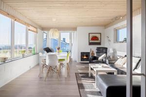 a living room with a table and a fireplace at LF888-Snedsted-Over-Reese-5 in Snedsted