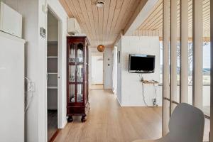 a living room with a tv and a couch at LF888-Snedsted-Over-Reese-5 in Snedsted