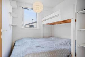 a white bedroom with a bunk bed and a window at LF888-Snedsted-Over-Reese-5 in Snedsted