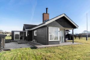 a small black house on a grass field at LF888-Snedsted-Over-Reese-5 in Snedsted