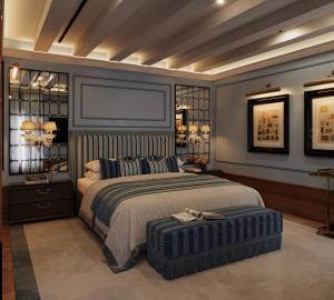 a bedroom with a bed and a ottoman in front of it at Locanda Cipriani in Torcello