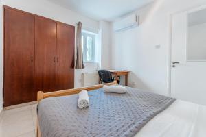 a bedroom with a bed with two towels on it at Andreas Beachfront Hostel in Larnaca