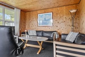 a living room with a couch and a table at LF14092-Roslev-Eskovvej-92 in Roslev