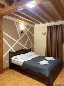 a bedroom with a large bed in a room at Park hotel SVYAT in Skole