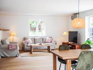 a living room with a couch and a table at 16655-Farevejle-Truntebakken-4 in Fårevejle