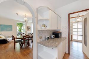 a kitchen and living room with a table and chairs at Casa al Lago in Sulzano