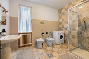 a bathroom with a toilet and a sink and a shower at Casa al Lago in Sulzano +20 photos