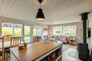 a kitchen and living room with a table and some windows at LF16021-Farso-Kjeldhoj-121 in Farsø +15 photos