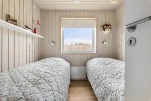 two beds in a bedroom with a window at LF16021-Farso-Kjeldhoj-121 in Farsø