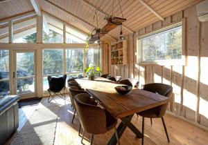 a dining room with a wooden table and chairs at 10055-1-Rorvig-Lindevangen-4 in Rørvig