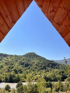 a view of a mountain from a wooden structure at Helios racha in Ambrolauri +2 photos