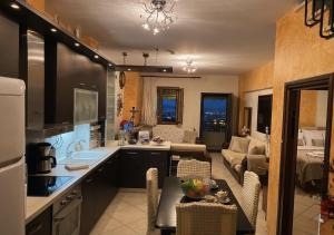 a kitchen and a living room with a couch at Aqua Mare Seaside Experience in Pyrgadikia