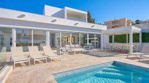 a villa with a swimming pool and a house at Maltese Luxury Villas - Sunset Infinity Pools, Indoor Heated Pools and More! in Mellieħa