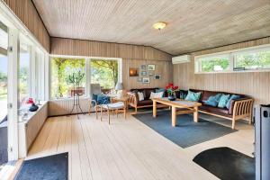 a living room with a couch and a table at 18008-Holbaek-Raevestien-5 in Holbæk