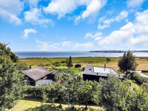 an aerial view of a house with the ocean in the background at 18008-Holbaek-Raevestien-5 in Holbæk