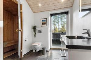 a bathroom with a toilet and a sink at 0259-Romo-Lyngvejen-89-B in Høm +31 photos