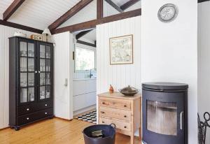a living room with a fireplace and a wooden floor at 13405-1-Hojby-Avaenget-1 in Højby +17 photos