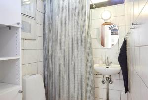 a bathroom with a shower curtain and a sink at 13405-1-Hojby-Avaenget-1 in Højby