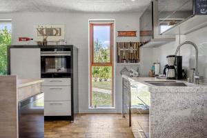 a kitchen with a sink and a counter top at LF10004-Thyholm-Agertoften-4 in Thyholm