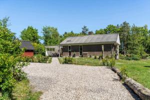 a house with a gravel driveway in front of it at LF10004-Thyholm-Agertoften-4 in Thyholm +12 photos