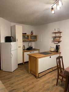 a kitchen with a white refrigerator and a table at Jagdstube in Prezelle
