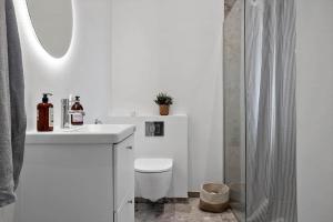 a white bathroom with a toilet and a sink at LF12003-Spottrup-Molleparken-32 in Spottrup