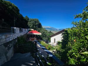 a stairway leading to a building with a red roof at Lemon Garden in Gjirokastër