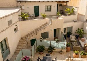 an apartment building with stairs and potted plants at B&B Alla Stazione in Palermo
