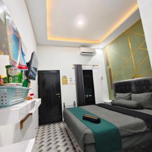 a bedroom with a bed and a black door at Wisma 11 Oktober in Palangkaraya