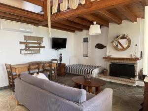 a living room with a couch and a fireplace at Alexia in Selinitsa