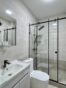 a bathroom with a toilet and a shower and a sink at Өркүндө in Chon-Sary-Oy +7 photos
