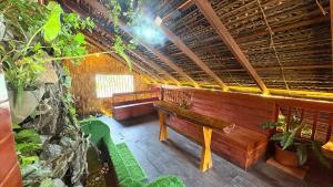 a wooden bench in a room with plants at Wonderful Hostel Trincomalee in Trincomalee