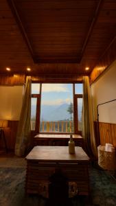 a room with a large window with a view at Almost Home in Shangarh