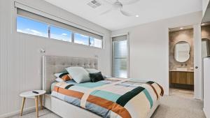 a bedroom with a large bed and a window at Luxury Townhouse Maroochydore in Maroochydore